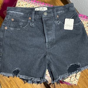 Brand New w/tags FREE PEOPLE black denim button fly distressed shorts. Size 24